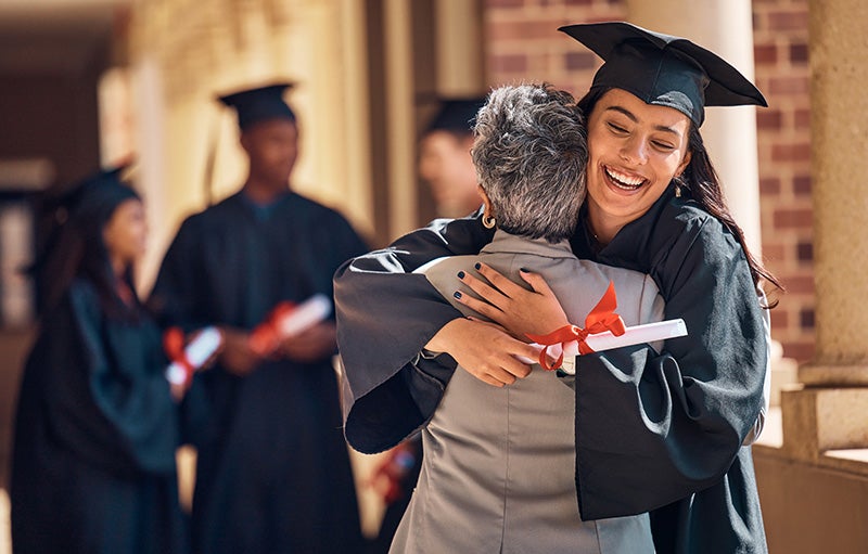 Graduated student hugging family