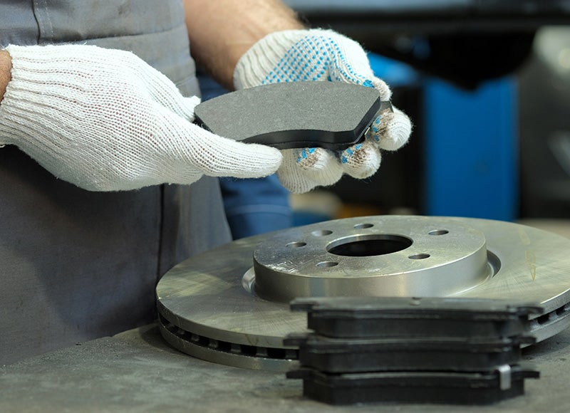 Mechanic checking over a brake pad