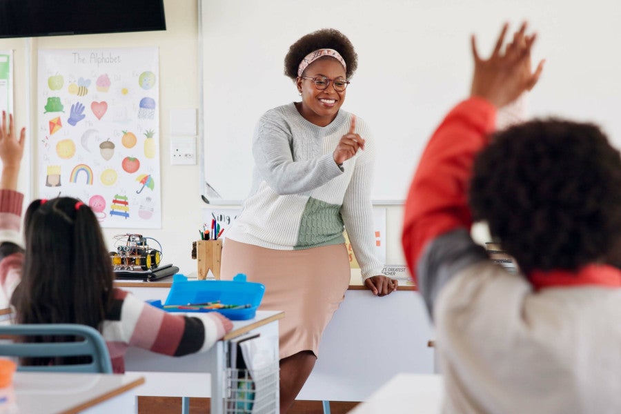 Teacher smiling and teaching classroom